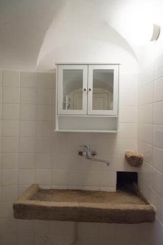 a bathroom with a sink and a cabinet at Château de Salamon - plage privée in Réquista