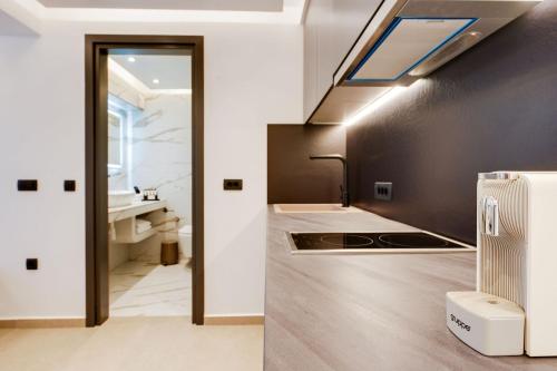 a bathroom with a sink and a sink at The Cosmopolitan - Karterados Urban Suites in Karterados