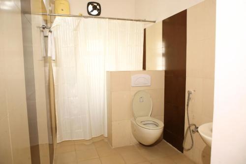 a small bathroom with a toilet and a sink at White Fern Stays Serviced Apartments - Gachibowli in Hyderabad