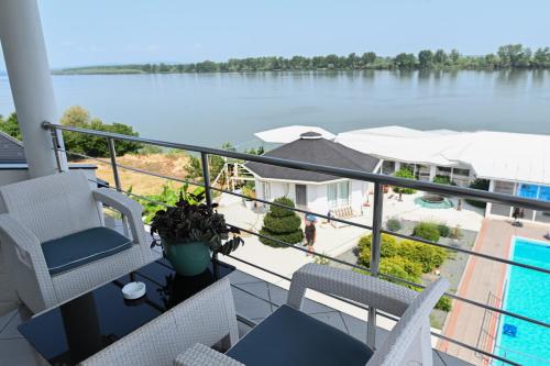 a balcony with chairs and a view of the water at Apartments Villa Graf in Smederevo