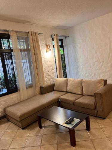 a living room with a couch and a coffee table at Joubarbe Residence in Moka