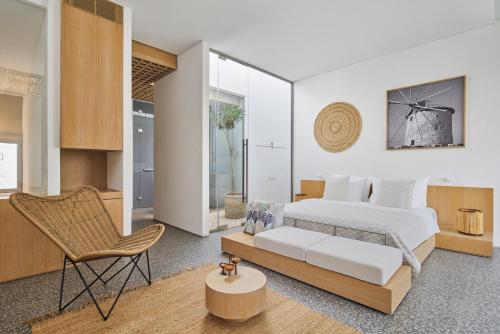 a bedroom with a bed and a chair at Voyage Torba Hotel in Torba