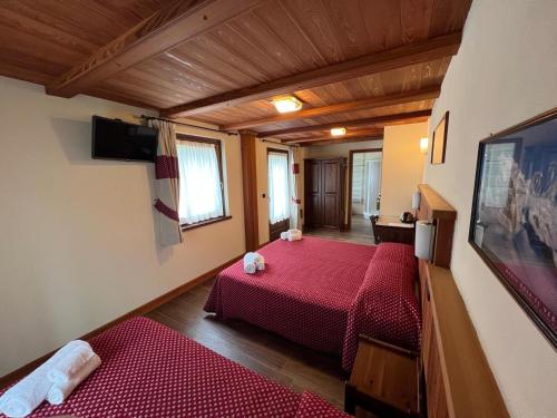 a bedroom with two beds in a room at Villa Americana Chambres d'Hotes in Champoluc