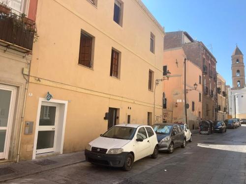 a group of cars parked next to a building at La Pola House Cagliari in Cagliari