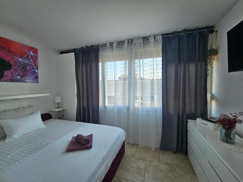a bedroom with a bed with a hat on it at Pipo Apartment Mareda in Novigrad Istria