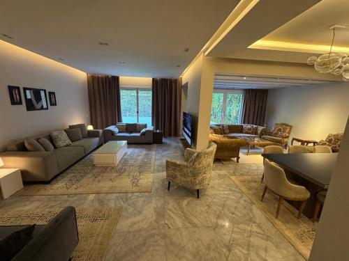 a large living room with a couch and a table at فيلا فندقية بالشيخ زايد - Zayed Suites B in Sheikh Zayed