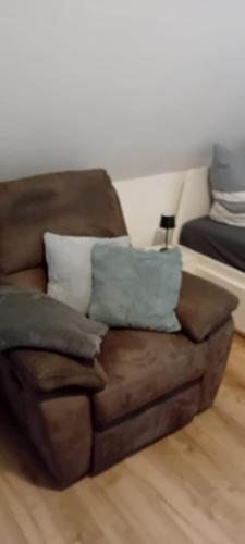 a brown couch with pillows in a living room at Apartment Nummer 4 in Twist