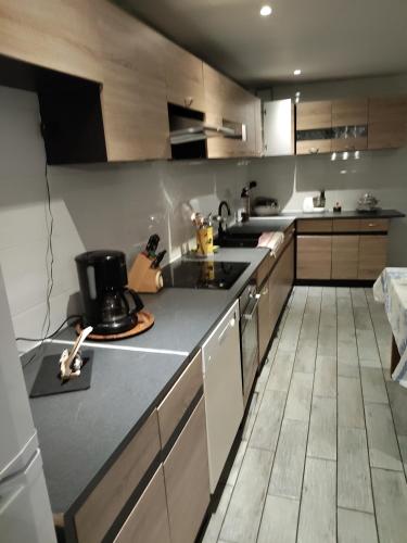 a kitchen with a sink and a counter top at Maison spacieuse et calme in Bayonville