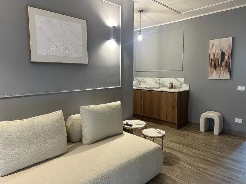 a living room with a couch and a table at Nouvelle Maison Rome Luxury Palace in Rome