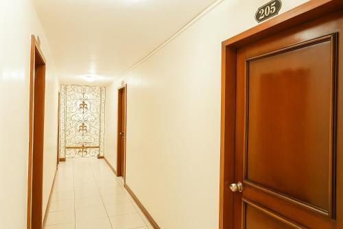 a hallway with a door and a tile floor at Goland Pension House & Dormitory by SMS Hospitality in Cebu City
