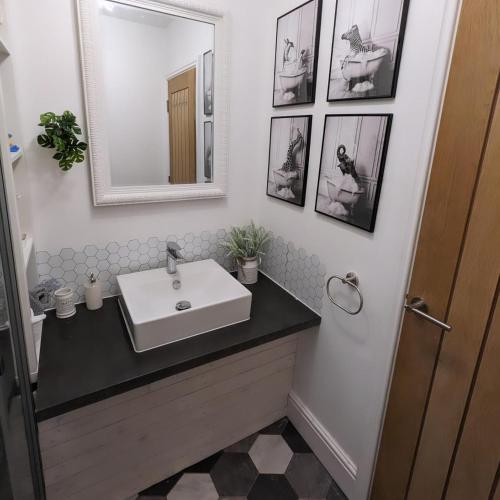 a bathroom with a sink and a mirror at The Stables - Private room in a shared house in Hartford