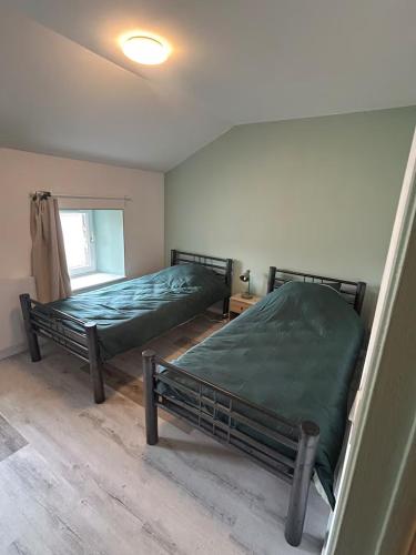 a bedroom with two beds and a window at Maison 4 personnes, TV connectée in Joinville