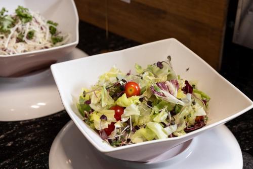 a salad in a white bowl on a table at Marysol by Haeundae beach in Busan