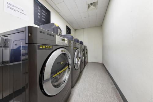 a row of washing machines in a laundry room at Marysol by Haeundae beach in Busan