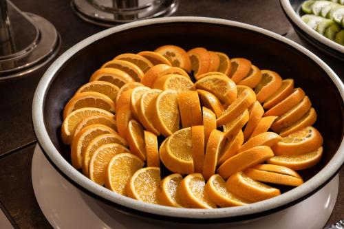 a bowl filled with orange slices on a table at Marysol by Haeundae beach in Busan