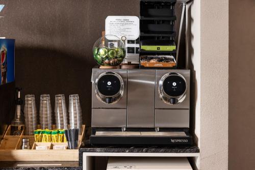 a coffee maker on top of a table at Marysol by Haeundae beach in Busan