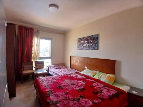 a bedroom with a bed with flowers on it at Aqua view North coast-الكيلو 91- in El Alamein