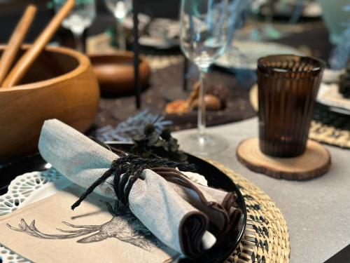 a table with a plate of food and a wine glass at 森の街34# Nature Escape BBQ in Wada