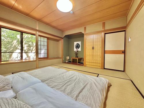 a bedroom with a large bed and a window at 森の街34# Nature Escape BBQ in Wada