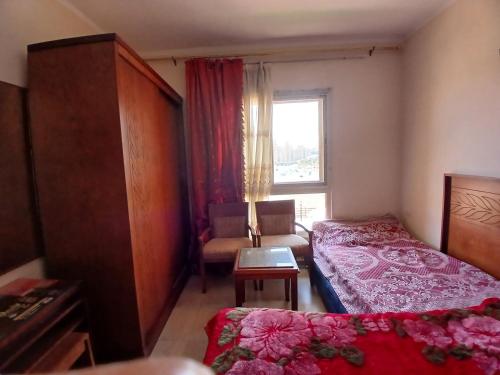 a hotel room with a bed and a window at Aqua view North coast-الكيلو 91- in El Alamein