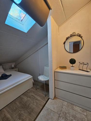 a bedroom with a bed and a mirror and a chair at Pipo Apartment Mareda in Novigrad Istria