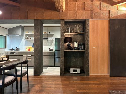 a kitchen with stainless steel appliances and a table and chairs at 森の街34# Nature Escape BBQ in Wada