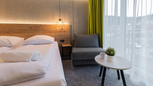 Кровать или кровати в номере VacationClub - Czarna Perła Apartament 201