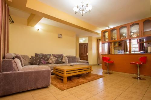 a living room with a couch and a coffee table at Ikonia Resort and Hotel in Kisumu