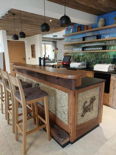 a bar in a room with chairs and a counter at Weingut Stoff in Kitzeck im Sausal