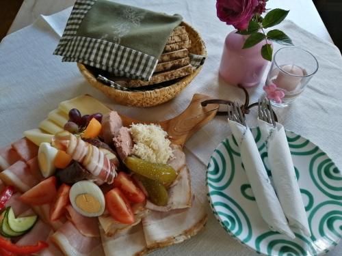 a plate of food with meat and vegetables on a table at Weingut Stoff in Kitzeck im Sausal