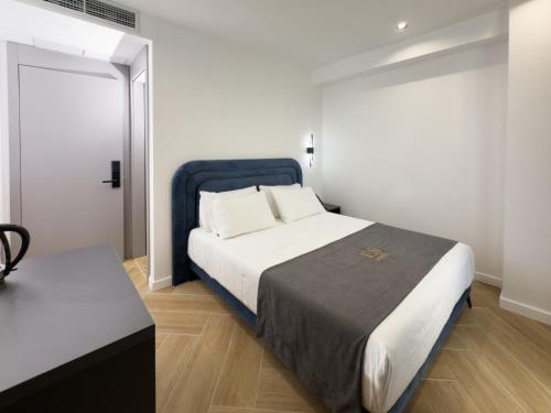 Ein Bett oder Betten in einem Zimmer der Unterkunft ES Hotel