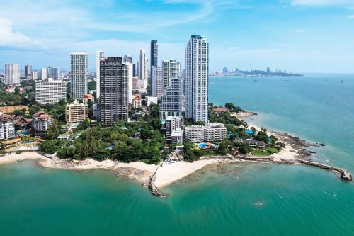 an aerial view of a city with a beach at Golden Tulip Pattaya Beachfront Resort in North Pattaya