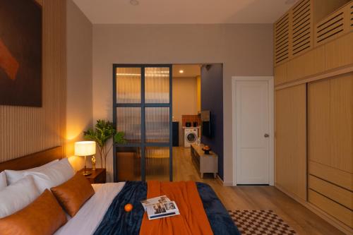 a bedroom with a bed with a book on it at DingD0ng Suites - The Sun Avenue - Free Pool & Gym in Ho Chi Minh City