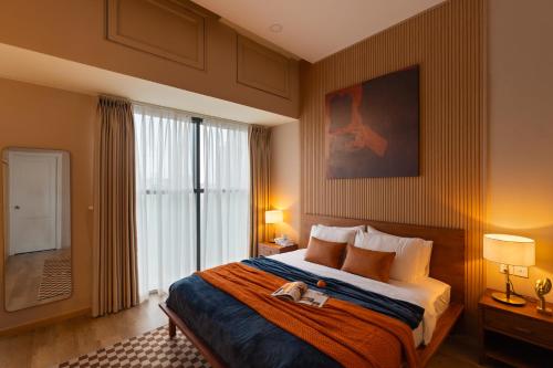 a hotel room with a bed and a large window at DingD0ng Suites - The Sun Avenue - Free Pool & Gym in Ho Chi Minh City