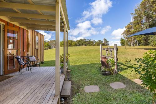 a porch of a house with a wooden deck at Country Cottage Sunshine Coast in Montville
