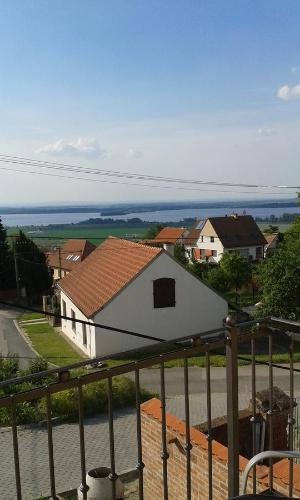 a white house with a red roof and a street at Ubytování pod Pálavou in Horní Věstonice