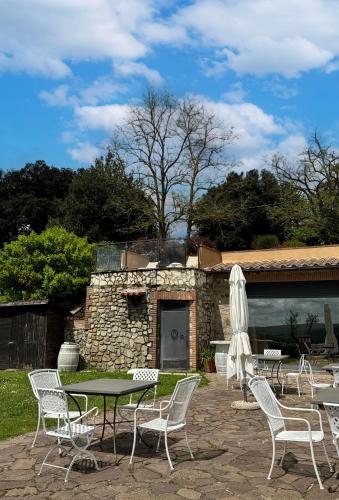 a patio with a table and chairs and a building at Borgo San Faustino Country Relais and Spa Orvieto in Orvieto