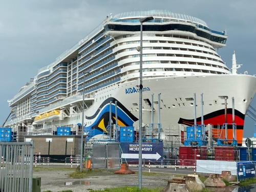 a large cruise ship is docked in a harbor at Bakker Huus EG in Emden