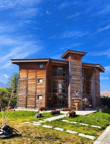 a large wooden house with a yard at Shackleton Chalet in Sestriere