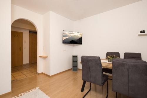 a dining room with a table and chairs at Appartements Huber in Fügen