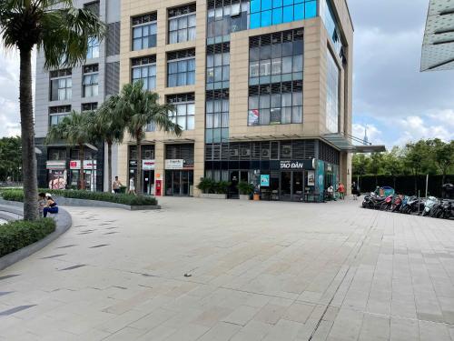 a large building with a parking lot in front of it at DingD0ng Suites - The Sun Avenue - Free Pool & Gym in Ho Chi Minh City