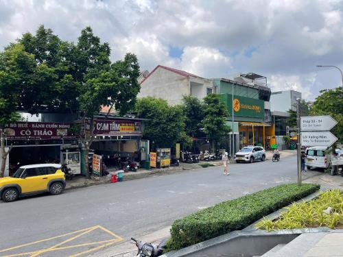 a street with cars parked on the side of the road at DingD0ng Suites - The Sun Avenue - Free Pool & Gym in Ho Chi Minh City