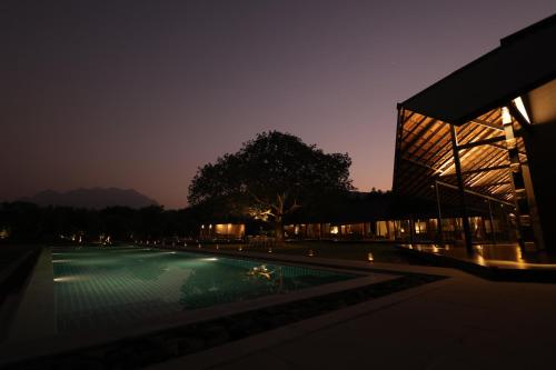 ein Gebäude mit Swimmingpool in der Nacht in der Unterkunft The Deck in Junagadh