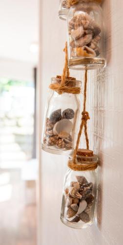 a group of four glass jars filled with rocks at De Zilte Zeehoeve in Ellemeet