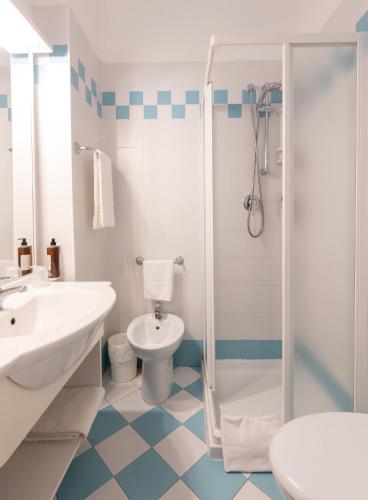a bathroom with a sink toilet and a shower at Hotel Jesulum in Lido di Jesolo