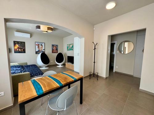 a bedroom with a bed and chairs in a room at Emma Casa Apartmant FREE Private Parking with EV supply availability in Budapest