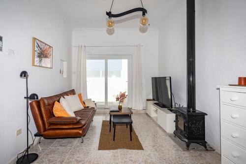 a living room with a couch and a stove at Luxury Beach La Concha Playa Honda in Playa Honda