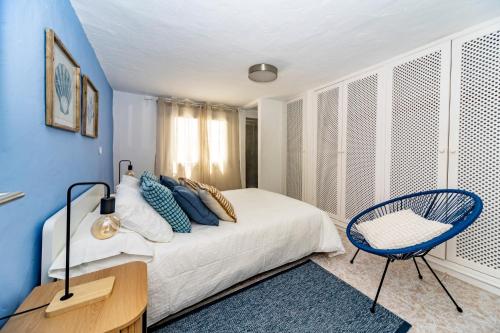a blue bedroom with a bed and a chair at Luxury Beach La Concha Playa Honda in Playa Honda