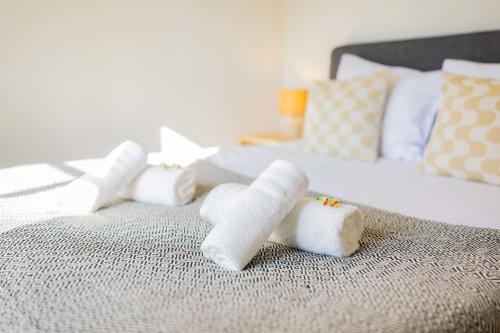 a pile of rolled up towels on a bed at Urban Luxe 70 m2 Two-Bedroom Apartment GB-62 in Eindhoven