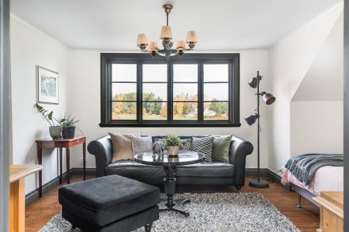 a living room with a couch and a table at Linden 1 in Gullberg